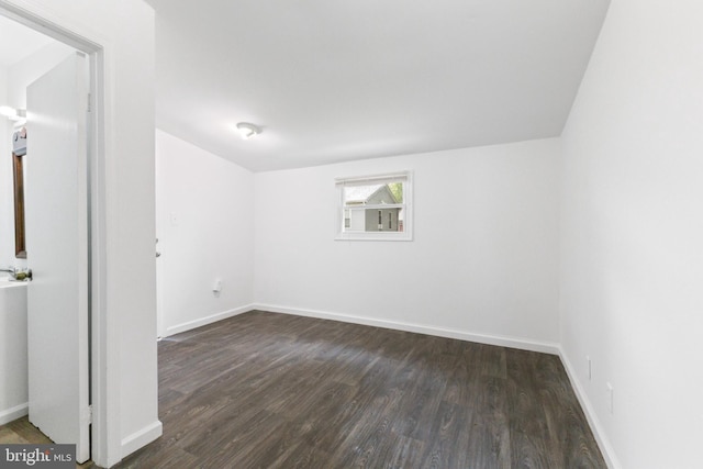 211 Broad St, Beverly, NJ 08010 - spare room featuring dark wood-type flooring and baseboards