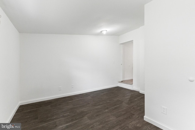 211 Broad St, Beverly, NJ 08010 - empty room with dark wood-style floors and baseboards