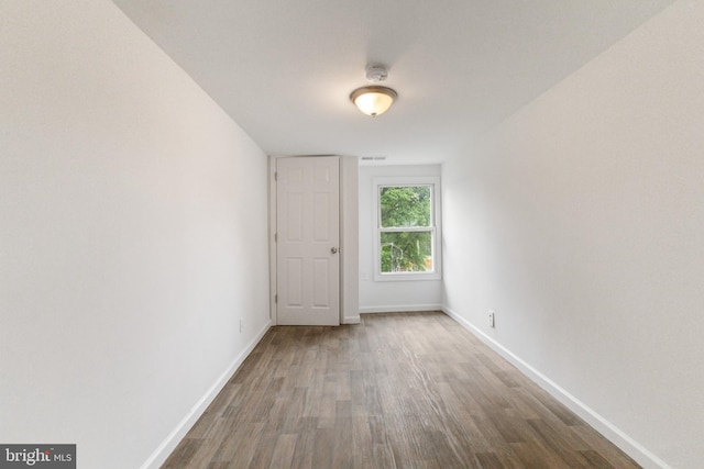 211 Broad St, Beverly, NJ 08010 - spare room with wood finished floors and a smoke detector