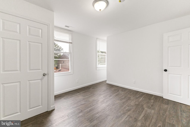 211 Broad St, Beverly, NJ 08010 - spare room featuring dark wood-style flooring and baseboards