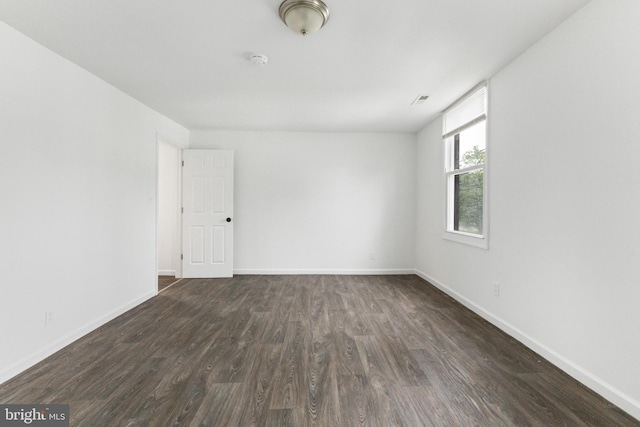 211 Broad St, Beverly, NJ 08010 - spare room featuring dark wood-style flooring and a smoke detector