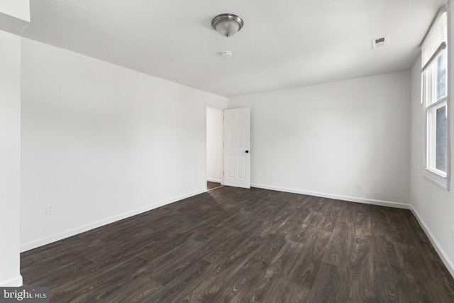 211 Broad St, Beverly, NJ 08010 - spare room featuring dark wood finished floors and baseboards
