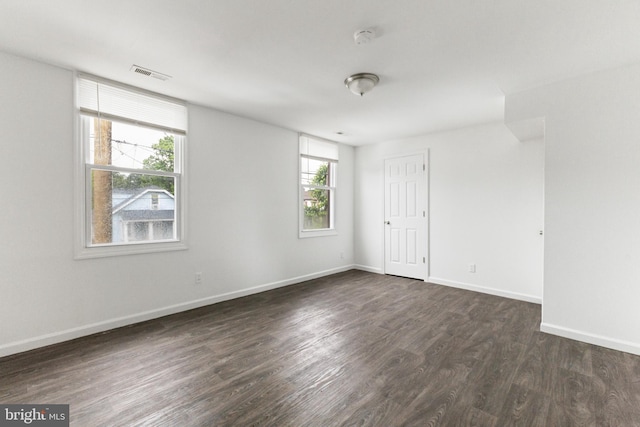 211 Broad St, Beverly, NJ 08010 - empty room featuring plenty of natural light, dark wood finished floors, and a smoke detector