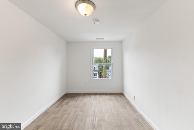 211 Broad St, Beverly, NJ 08010 - spare room with light wood-style flooring and a smoke detector