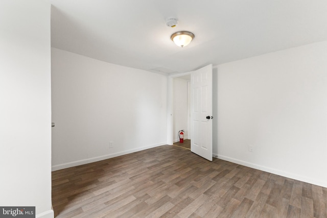 211 Broad St, Beverly, NJ 08010 - spare room featuring wood finished floors and a smoke detector