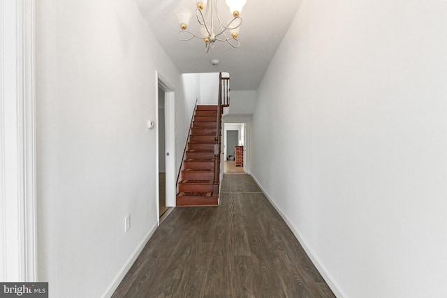 211 Broad St, Beverly, NJ 08010 - hallway with stairs, dark wood finished floors, and a chandelier