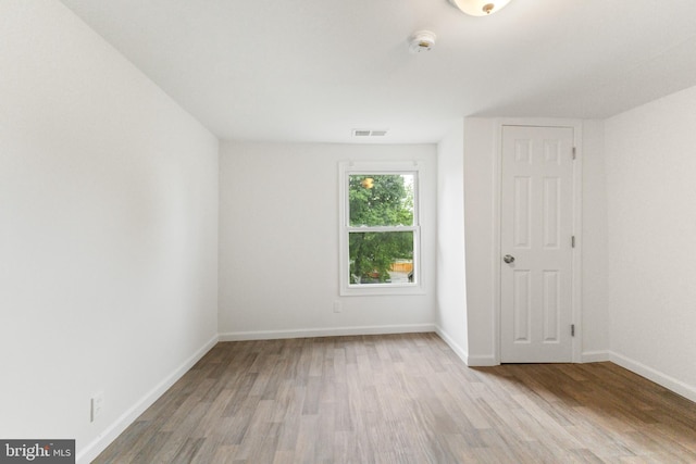211 Broad St, Beverly, NJ 08010 - empty room with wood finished floors and a smoke detector