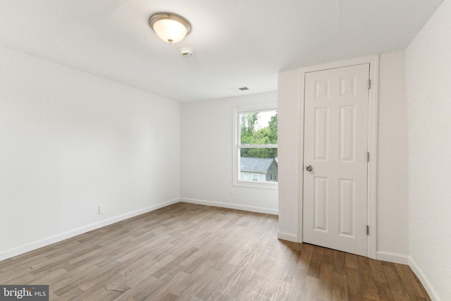 211 Broad St, Beverly, NJ 08010 - spare room featuring wood finished floors and a smoke detector