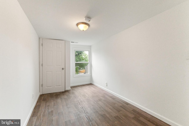 211 Broad St, Beverly, NJ 08010 - spare room with a smoke detector and wood finished floors