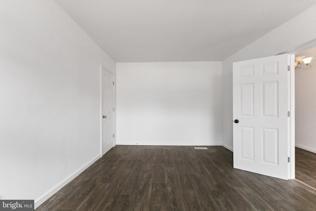 211 Broad St, Beverly, NJ 08010 - empty room featuring dark wood-style floors, vaulted ceiling, and a chandelier