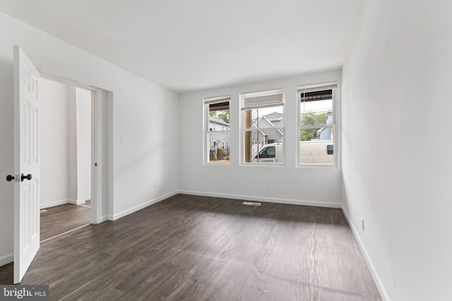 211 Broad St, Beverly, NJ 08010 - empty room featuring dark wood finished floors and baseboards
