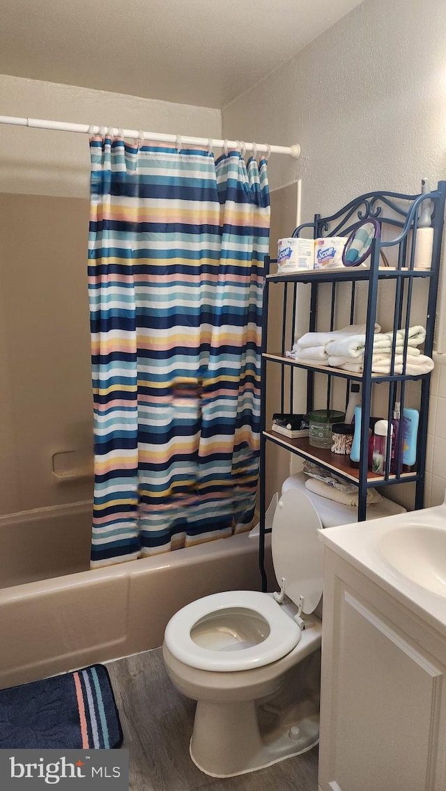 1025 Fredonia Ct, Baltimore, MD 21227 - full bath with shower / bath combination with curtain, vanity, a textured wall, and wood finished floors