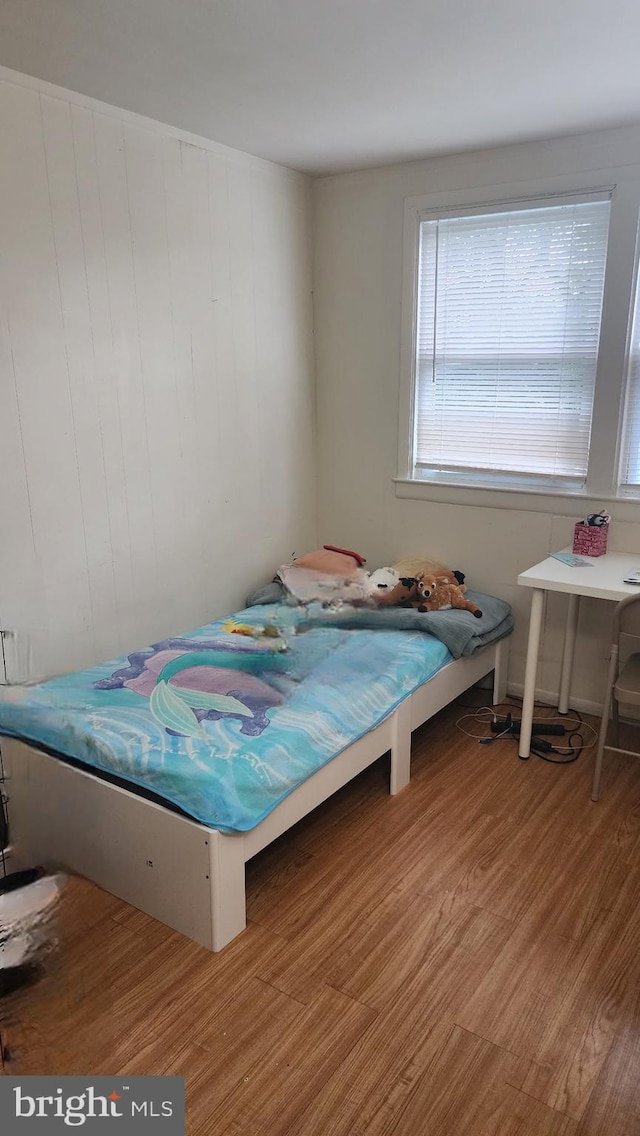 1025 Fredonia Ct, Baltimore, MD 21227 - bedroom with wood finished floors and wooden walls
