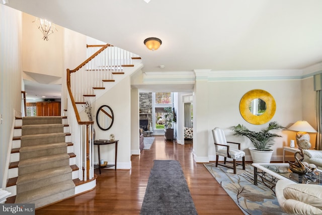 3716 Taft Ave, Alexandria, VA 22304 - foyer featuring stairway, wood finished floors, crown molding, and a fireplace