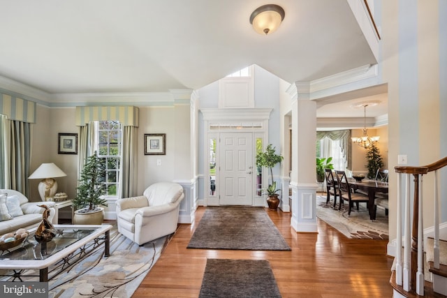 3716 Taft Ave, Alexandria, VA 22304 - entrance foyer featuring healthy amount of natural light, light wood-type flooring, crown molding, a chandelier, and ornate columns