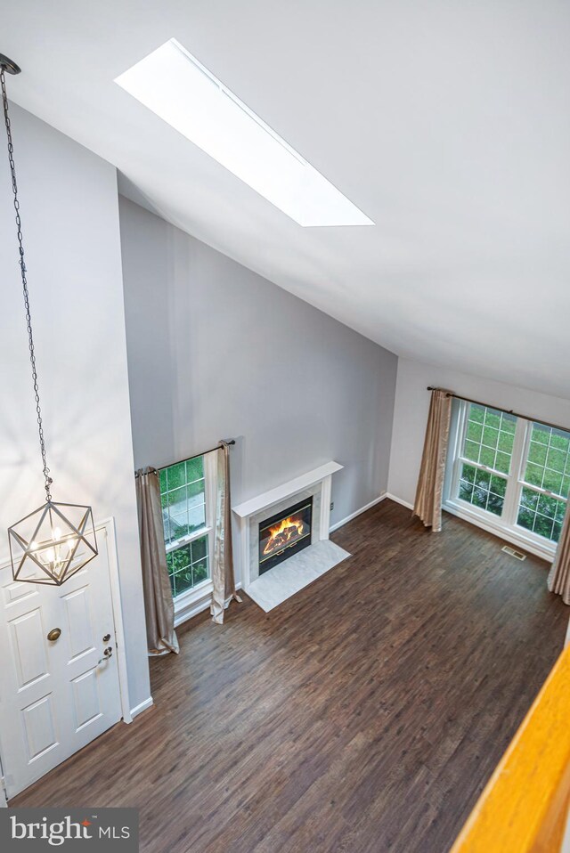 1651 Hugo Cir, Silver Spring, MD 20906 - unfurnished living room with a skylight, a chandelier, dark wood finished floors, and lofted ceiling
