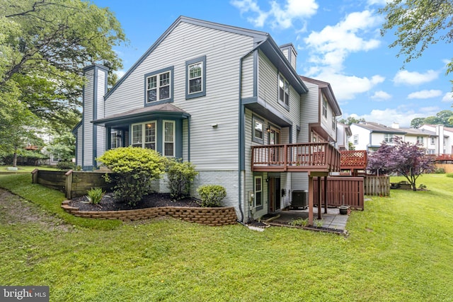 1651 Hugo Cir, Silver Spring, MD 20906 - rear view of house with a chimney, a wooden deck, a lawn, and a patio