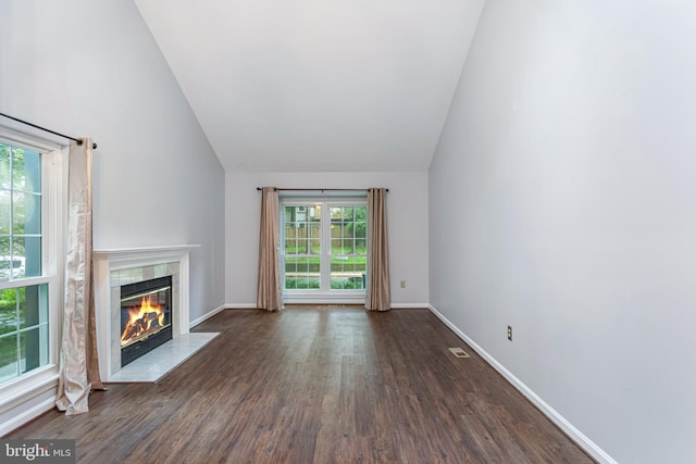 1651 Hugo Cir, Silver Spring, MD 20906 - unfurnished living room featuring lofted ceiling, a fireplace, dark wood-style flooring, and healthy amount of natural light