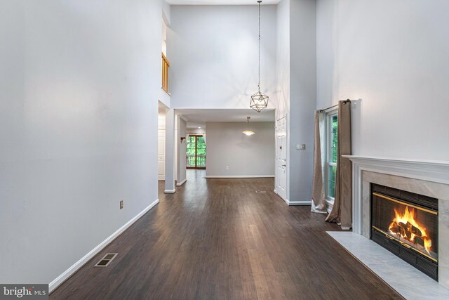 1651 Hugo Cir, Silver Spring, MD 20906 - unfurnished living room featuring a towering ceiling, a high end fireplace, and wood finished floors