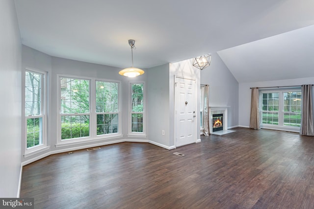 1651 Hugo Cir, Silver Spring, MD 20906 - unfurnished living room featuring plenty of natural light, dark wood-style floors, and vaulted ceiling