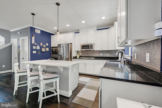 2596 Twin Birch Rd, Hanover, MD 21076 - kitchen with stainless steel appliances, tasteful backsplash, a breakfast bar area, dark wood-style flooring, and white cabinets