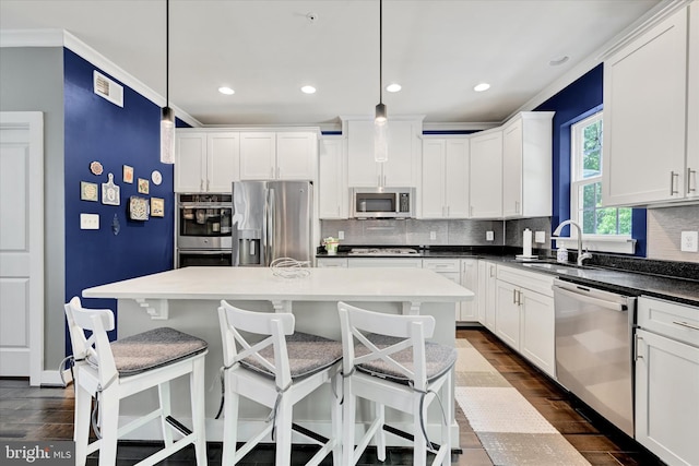 2596 Twin Birch Rd, Hanover, MD 21076 - kitchen featuring stainless steel appliances, backsplash, dark wood-style flooring, recessed lighting, and white cabinets