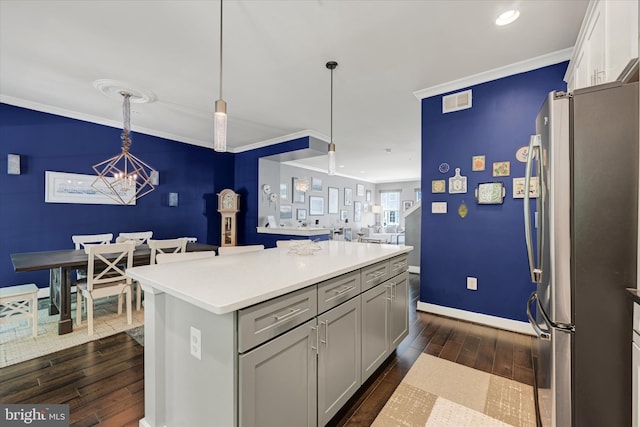2596 Twin Birch Rd, Hanover, MD 21076 - kitchen with freestanding refrigerator, dark wood-type flooring, a chandelier, ornamental molding, and pendant lighting
