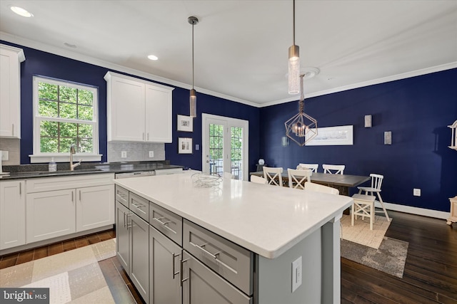 2596 Twin Birch Rd, Hanover, MD 21076 - kitchen with recessed lighting, dark wood-style flooring, ornamental molding, a kitchen island, and hanging light fixtures