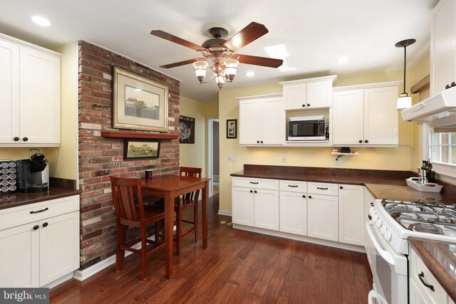 9 Morningside Dr, Pennington, NJ 08534 - kitchen featuring dark countertops, white range with gas stovetop, a ceiling fan, dark wood-style floors, and white cabinetry