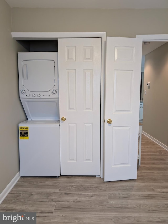 532 Sunrise Ave, Harbour View, Somers Point, NJ 08244 - laundry area with stacked washing machine and dryer and light wood-type flooring
