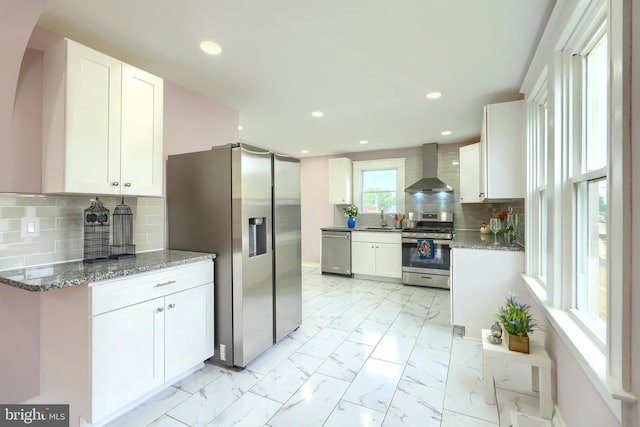 2721 Louise Ave, Baltimore, MD 21214 - kitchen featuring stainless steel appliances, wall chimney exhaust hood, light marble finish floors, white cabinetry, and recessed lighting
