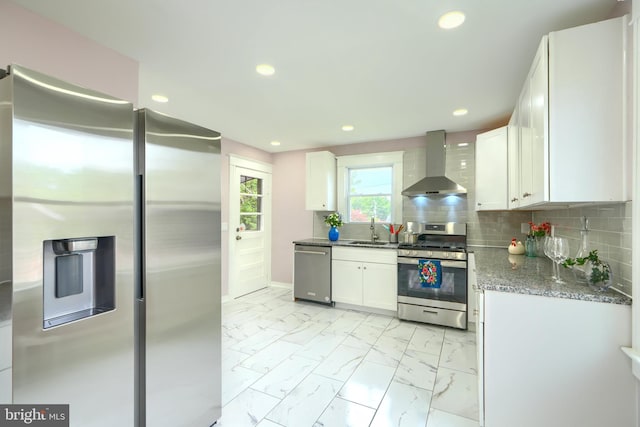 2721 Louise Ave, Baltimore, MD 21214 - kitchen with appliances with stainless steel finishes, wall chimney range hood, light marble finish floors, white cabinetry, and recessed lighting