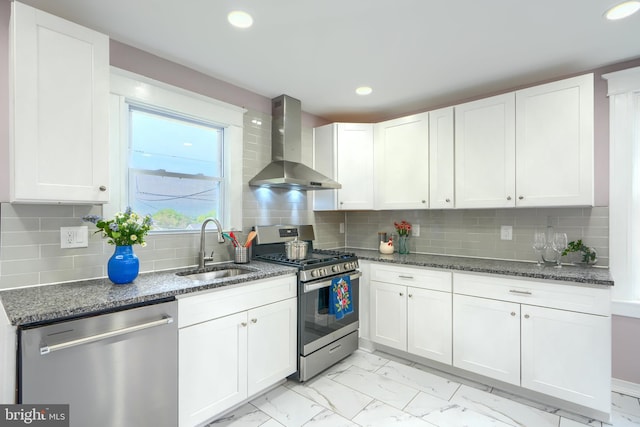 2721 Louise Ave, Baltimore, MD 21214 - kitchen featuring wall chimney exhaust hood, appliances with stainless steel finishes, light marble finish flooring, dark stone counters, and recessed lighting