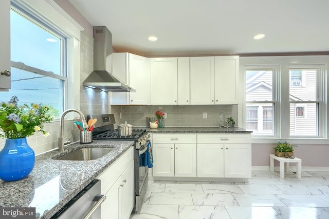 2721 Louise Ave, Baltimore, MD 21214 - kitchen with wall chimney exhaust hood, appliances with stainless steel finishes, plenty of natural light, light marble finish flooring, and recessed lighting