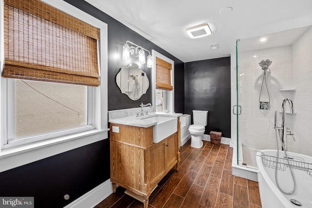 307 S Exeter St, Baltimore, MD 21202 - bathroom featuring vanity, a freestanding tub, wood finished floors, and a stall shower