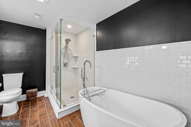 307 S Exeter St, Baltimore, MD 21202 - full bathroom with a freestanding tub, wood finish floors, a shower stall, and recessed lighting