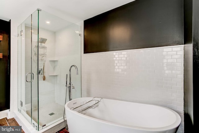 307 S Exeter St, Baltimore, MD 21202 - bathroom featuring a freestanding bath, a stall shower, and tile walls
