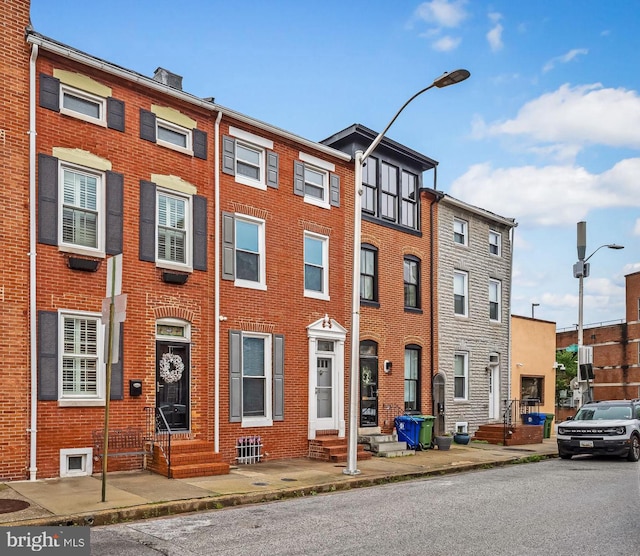 307 S Exeter St, Baltimore, MD 21202 - view of front facade featuring entry steps and brick siding