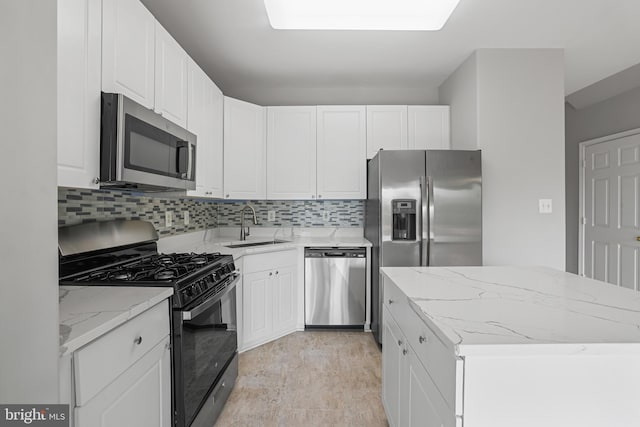 21024 Mossy Glen Ter, Ashburn, VA 20147 - kitchen featuring stainless steel appliances, a center island, decorative backsplash, white cabinetry, and light stone countertops