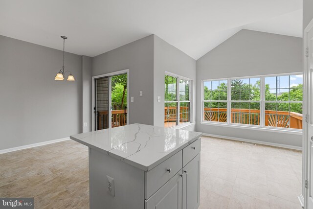 21024 Mossy Glen Ter, Ashburn, VA 20147 - kitchen featuring a chandelier, a center island, vaulted ceiling, hanging light fixtures, and light stone countertops
