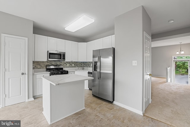 21024 Mossy Glen Ter, Ashburn, VA 20147 - kitchen featuring stainless steel appliances, decorative backsplash, white cabinetry, a center island, and light stone countertops