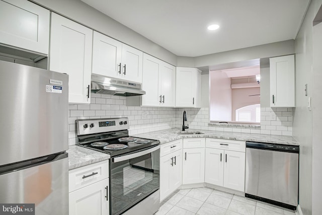 825 N 29th St Unit 1B, Philadelphia, PA 19130 - kitchen with appliances with stainless steel finishes, under cabinet range hood, white cabinetry, backsplash, and recessed lighting