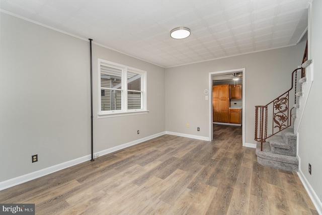 324 N 2nd St, Lykens, PA 17048 - spare room with wood finished floors, stairs, crown molding, and ceiling fan