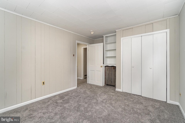 324 N 2nd St, Lykens, PA 17048 - unfurnished bedroom with carpet floors, a closet, ornamental molding, and wooden walls