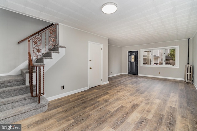 324 N 2nd St, Lykens, PA 17048 - unfurnished living room featuring radiator, stairway, and wood finished floors