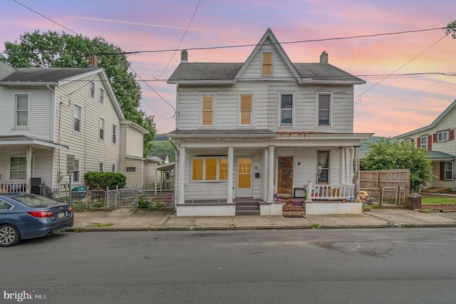 324 N 2nd St, Lykens, PA 17048 - townhome / multi-family property with a porch, a chimney, and a gate