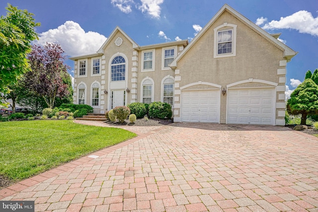 8 Cove Ct, Hainesport, NJ 08036 - colonial inspired home with decorative driveway, a front yard, and stucco siding