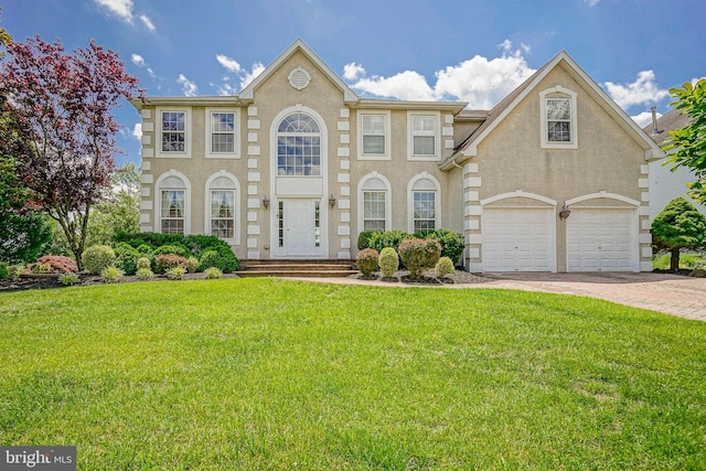 8 Cove Ct, Hainesport, NJ 08036 - georgian-style home with a front yard, driveway, and stucco siding