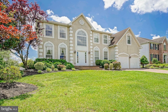 8 Cove Ct, Hainesport, NJ 08036 - colonial home featuring a garage, a front lawn, driveway, and stucco siding