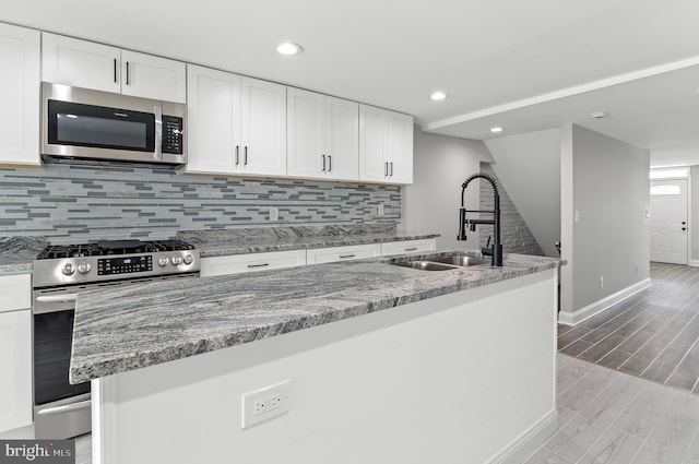 816 Carroll St, Baltimore, MD 21230 - kitchen featuring appliances with stainless steel finishes, tasteful backsplash, white cabinetry, and recessed lighting